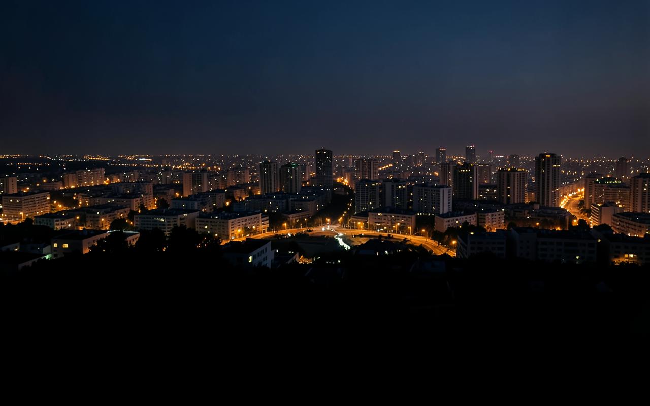 City skyline at dusk with warm lights under a deep navy sky